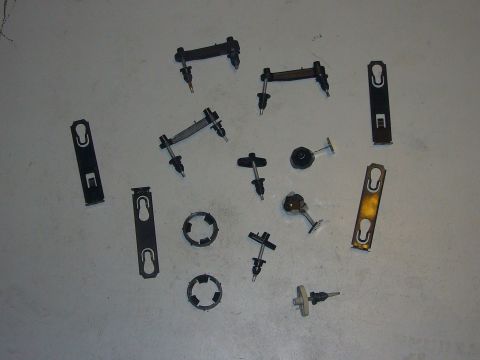 2000 Ford Crown Victoria - Various automotive clips and fasteners are laid out on a flat surface.