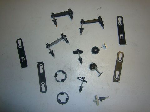 2000 Ford Crown Victoria - A collection of various automotive clips and fasteners are displayed on a flat surface.