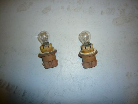 2000 Ford Crown Victoria - Two automotive light bulbs are shown against a neutral background.