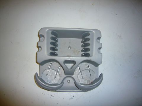 2000 Ford Crown Victoria - This gray plastic insert appears to be a cup holder assembly, possibly from a vehicle's interior.