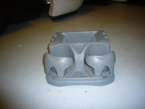2000 Ford Crown Victoria - This is a gray plastic center console cup holder assembly.