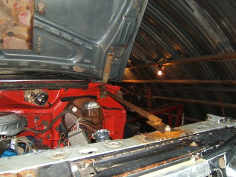 1980 Ford F-250 - The engine bay of a 1980 Ford F-250 shows red painted inner fenders and various engine components under the hood.