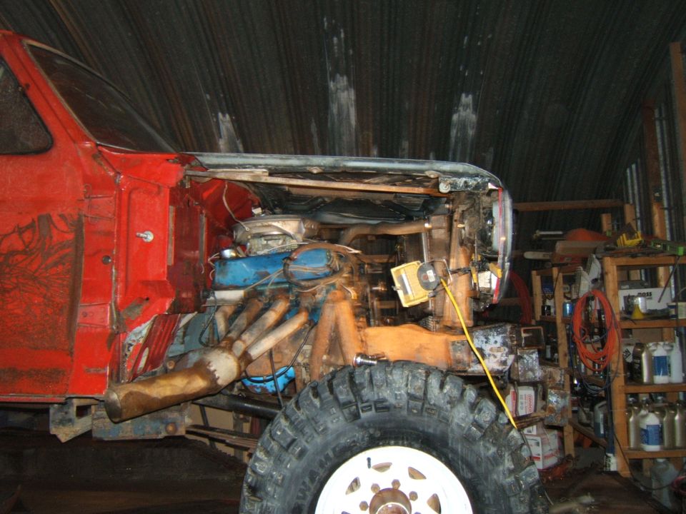 1980 Ford F-250 front end with engine exposed, showing custom exhaust and large tires