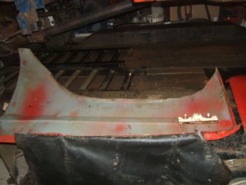 1980 Ford F-250 - A disassembled vehicle fender part is shown in a workshop setting.