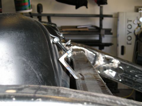 1986 Toyota Hilux - Detail of a fuel tank mounting bracket with hardware visible.