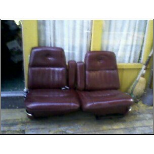 1973 Ford Ranchero - Pair of maroon car seats, likely from a vintage vehicle, are shown with a center console in between.