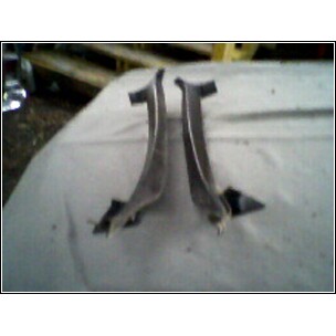 1973 Ford Ranchero - Two metal trim pieces are shown laid out on a white surface.