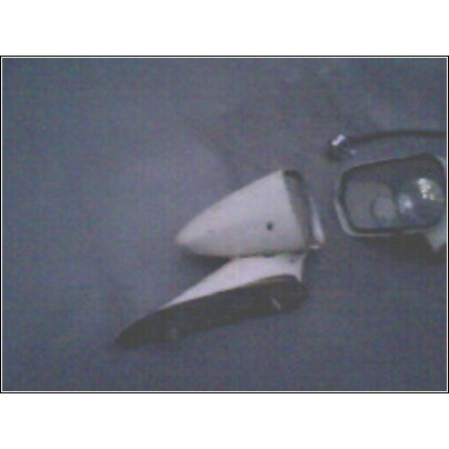 1973 Ford Ranchero - A white fender ornament and side mirror are shown against a plain background.