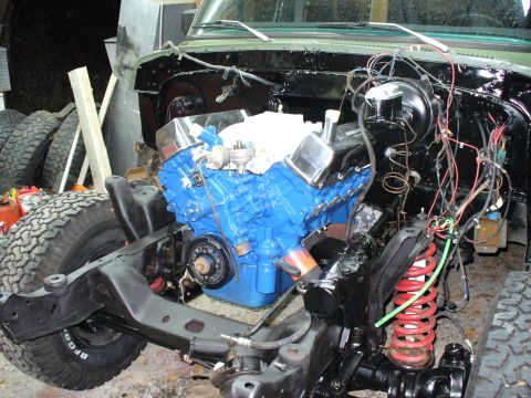 1978 Ford Bronco - Engine bay of a 1978 Ford Bronco undergoing a 460 engine swap, with the new blue engine installed.