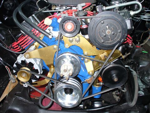 1978 Ford Bronco - Front view of a blue V8 engine's accessory drive with gold anodized serpentine/V-belt brackets, polished aluminum water pump and crank pull…