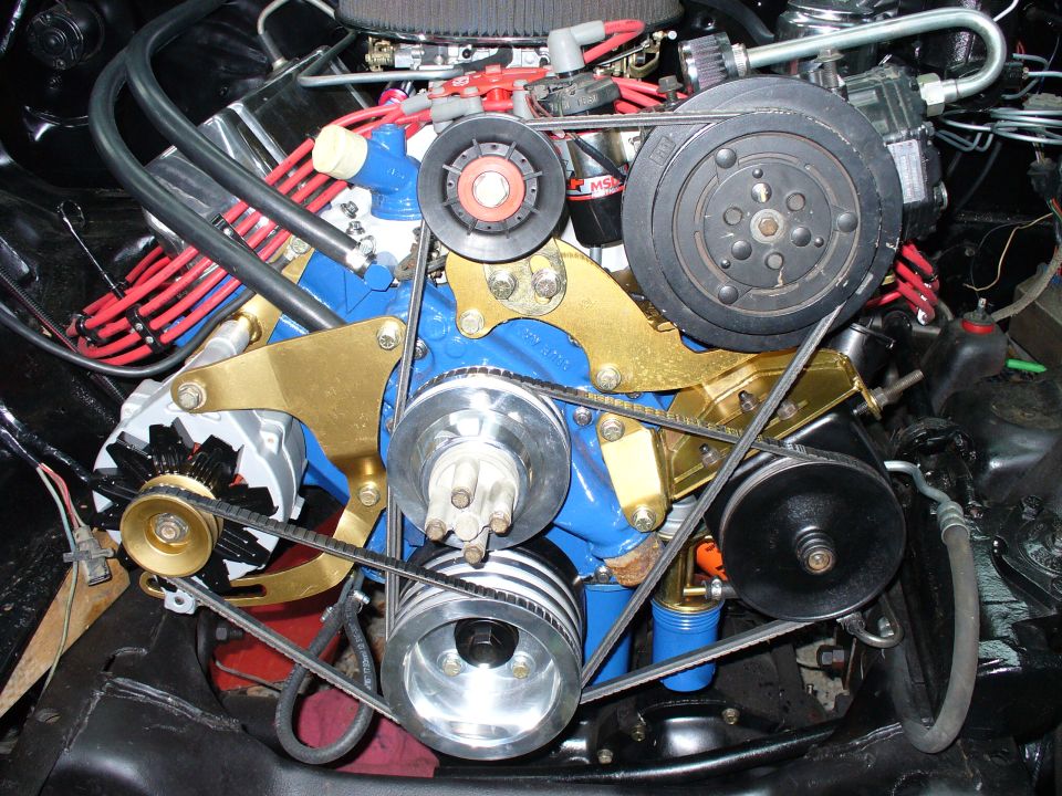 Blue V8 front with gold accessory brackets, polished pulleys, A/C compressor and red plug wires