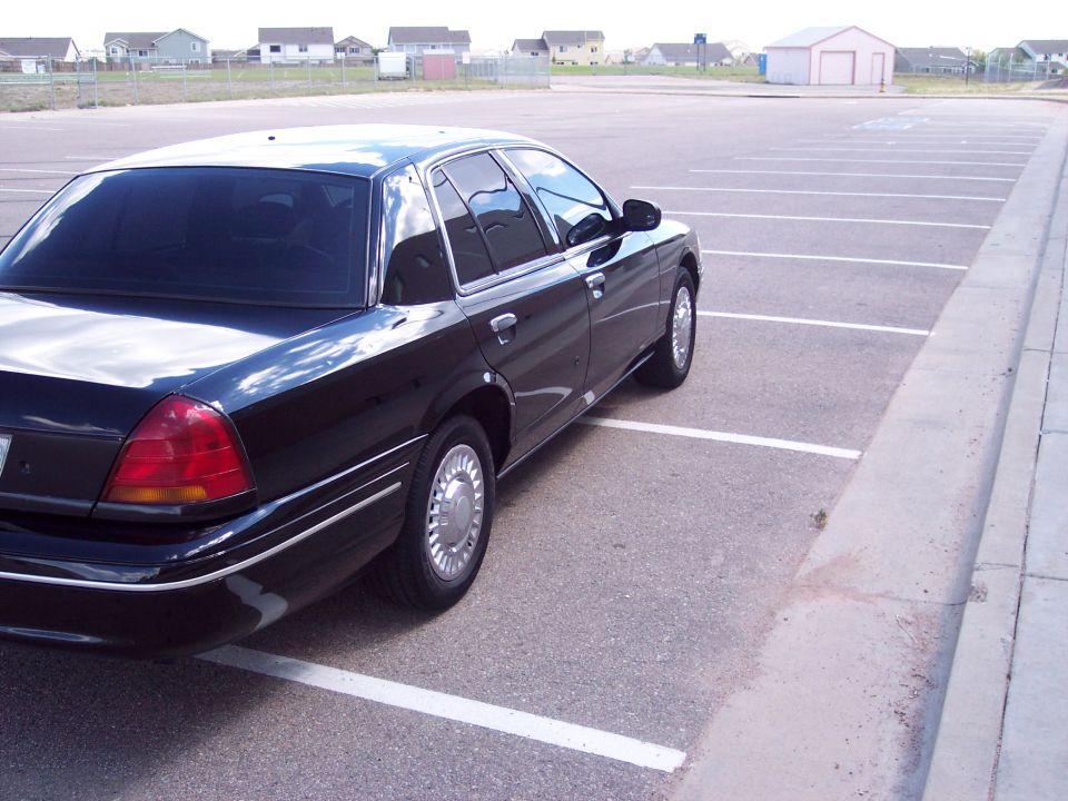 Black 1998 Ford Crown Victoria, rear 3/4 view