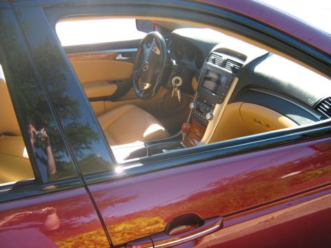 1990 Ford Bronco - Interior view of a car's cabin with tan leather seats and wood trim accents.