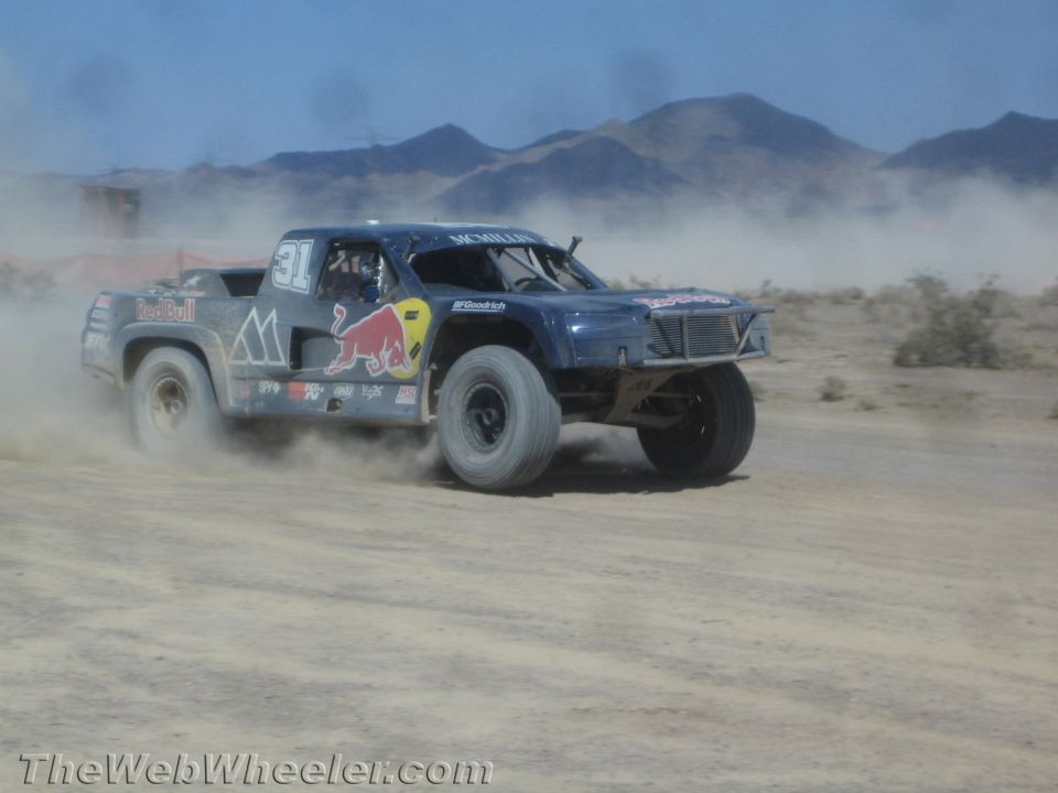 Blue Red Bull off-road race truck cornering in the desert
