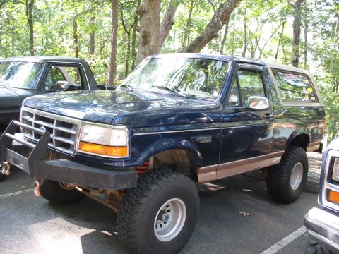 1995 Ford C-350 (Centurion Conversions) - This lifted Ford Bronco has a custom bumper and appears to be from the early to mid-1990s.