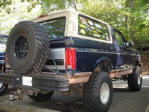1995 Ford C-350 (Centurion Conversions) - Lifted Ford Bronco with large off-road tires and a spare tire on the rear.