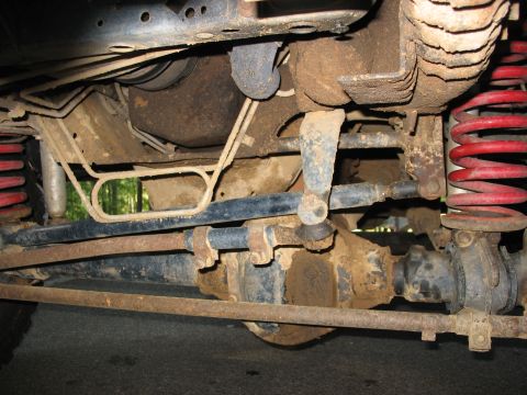 1995 Ford C-350 (Centurion Conversions) - Close-up of a vehicle's undercarriage, revealing suspension and drivetrain parts.