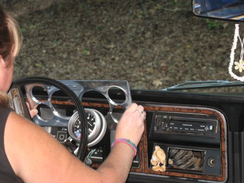1995 Ford C-350 (Centurion Conversions) - A person's hands are on the steering wheel of a vehicle, with the dashboard and radio visible.