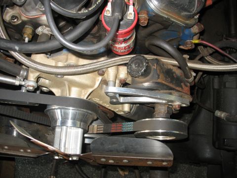 1995 Ford C-350 (Centurion Conversions) - Close-up view of engine components including the power steering pump and drive belts.