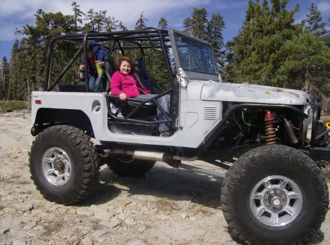 1986 Ford Bronco - This heavily modified off-road vehicle features a prominent roll cage and oversized tires.