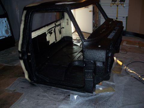 1979 Ford F-150 - The interior of a truck cab, likely from the 1970s, is being treated with a protective coating.