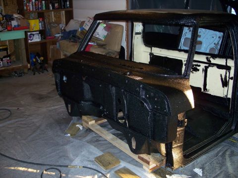 1979 Ford F-150 - The cab of a 1979 Ford F-150 is shown with a black textured coating applied, likely during a restoration process.