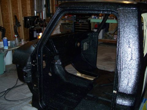 1979 Ford F-150 - The interior of a truck cab has been coated with a textured black protective material.