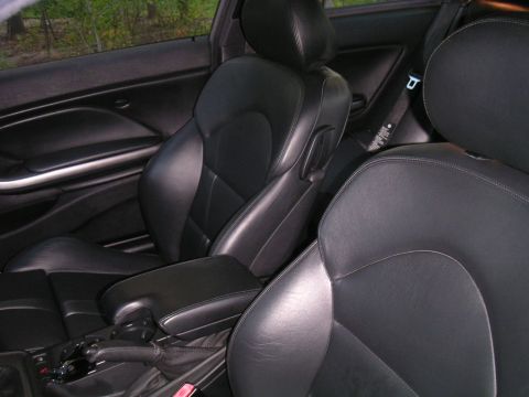 2002 BMW M3 - Interior view of a car's front seats and console, with a watermark visible.