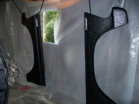 1979 Ford F-150 - Two fender flares are being painted, covered in overspray from a recent spray job.