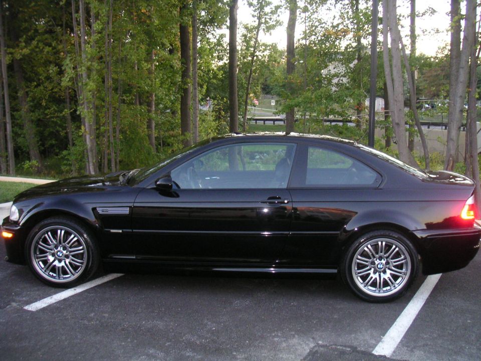 Black BMW E46 M3 coupe side profile with silver M double-spoke wheels