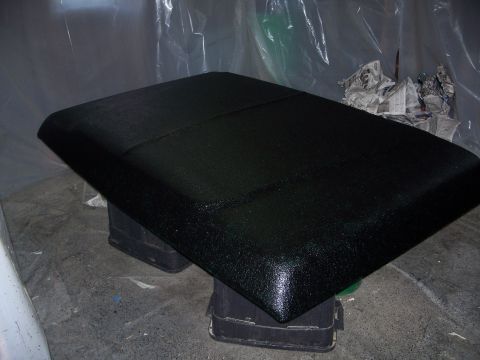 1979 Ford F-150 - A black textured truck bed liner is shown resting on blocks, possibly during a restoration or customization process.