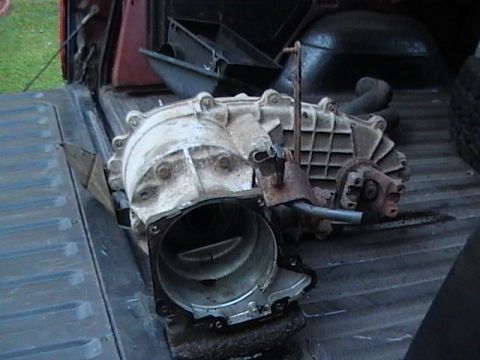 1990 Ford Bronco - A used transfer case is shown in the bed of a pickup truck.