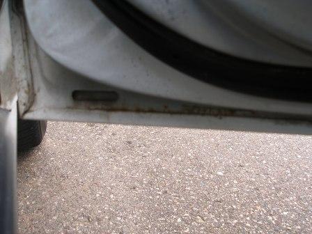 2000 Ford Crown Victoria - Door jamb detail showing rust and a rubber seal.
