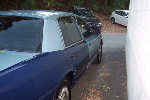 2001 Ford Crown Victoria - This 2001 Ford Crown Victoria features a distinctive two-tone blue paint scheme, seen here from the side with other vehicles in the backgro…