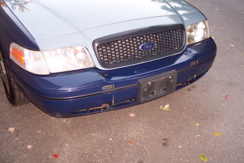 2001 Ford Crown Victoria - Front view of a two-tone blue and light blue 2001 Ford Crown Victoria, showing the grille and headlights.
