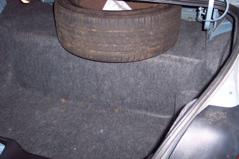 2001 Ford Crown Victoria - Spare tire is visible in the trunk of a vehicle.