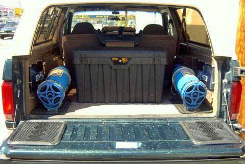 1992 Ford Bronco - Rear cargo area of a 1992 Ford Bronco, equipped with aftermarket speakers and a large toolbox.