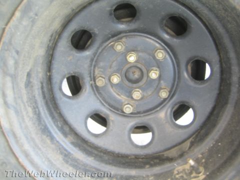 1987 Suzuki Samurai - Close-up view of a vehicle's wheel and tire assembly.