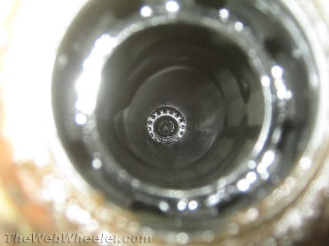 1987 Suzuki Samurai - The interior of a broken axle tube shows a circular flange with multiple holes, indicating a significant mechanical failure.