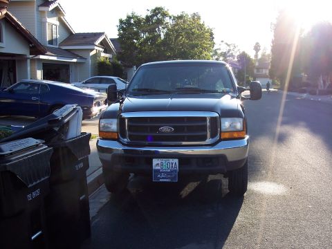 2000 Ford F-250 - Black 2000 Ford F-250 parked curbside in front of a house.