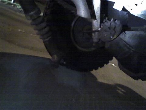 1992 Ford Bronco - A close-up view of a vehicle's tire and suspension system is visible.