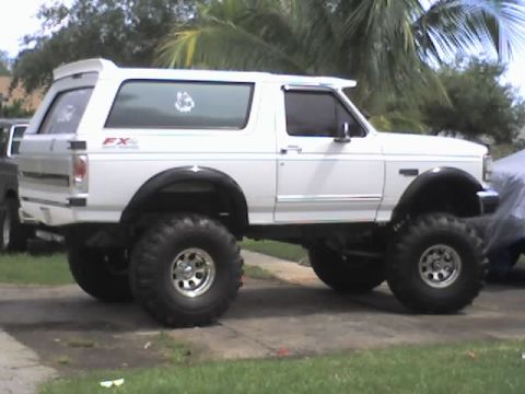 1995 Ford Bronco - This lifted 1995 Ford Bronco features an aggressive stance with oversized tires and suspension modifications.