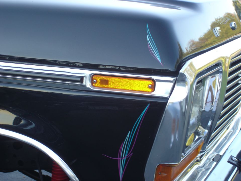 1979 Ford F-250 front fender with amber turn signal and pinstripe graphics