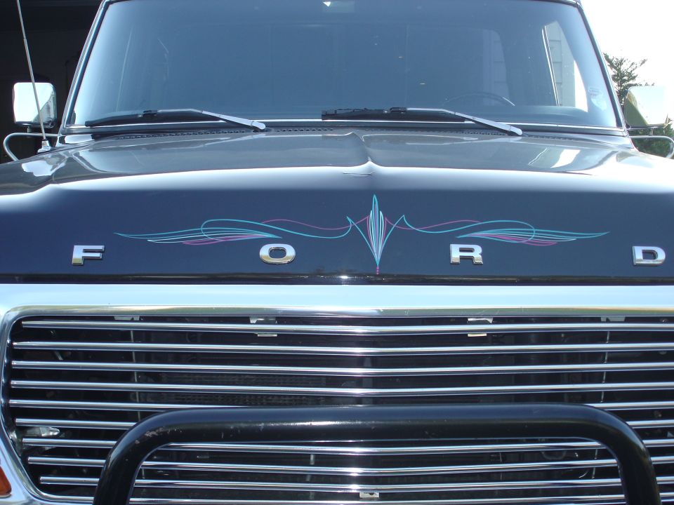 Dark blue Ford F-250 hood with pinstriping and chrome grille