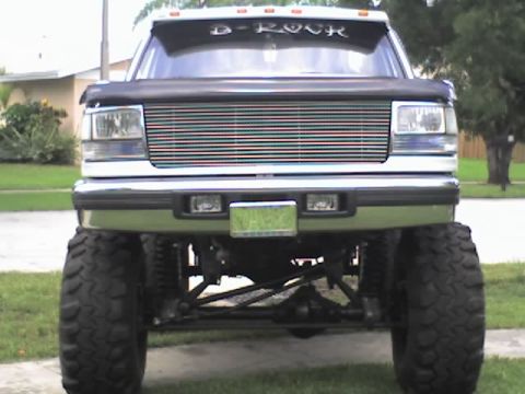 1995 Ford Bronco - This 1995 Ford Bronco features a lifted suspension, custom grille, and a "D-ROCK" decal on the windshield.