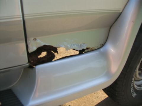 1995 Ford C-350 (Centurion Conversions) - Significant rust damage is visible on the lower body panel of this vehicle.