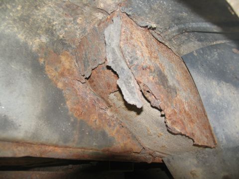 1995 Ford C-350 (Centurion Conversions) - Severe rust damage is visible on a vehicle's undercarriage frame.