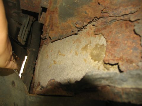 1995 Ford C-350 (Centurion Conversions) - Significant rust and deterioration are visible on the vehicle's frame and undercarriage, with insulation exposed.