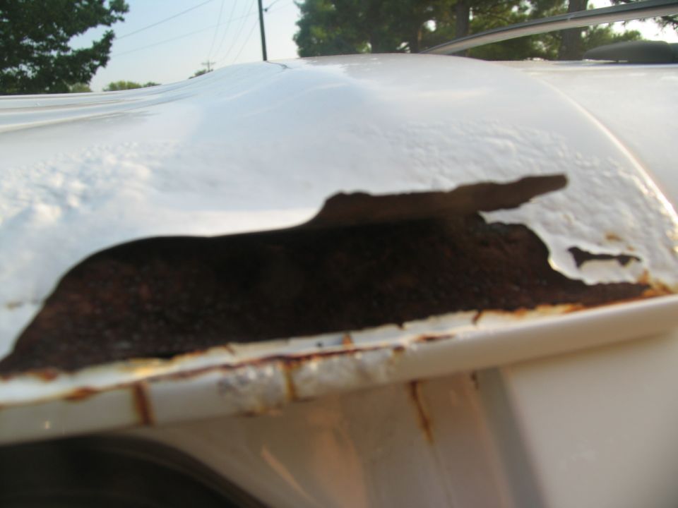 White vehicle roof showing extensive rust and peeling paint