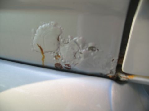 1995 Ford C-350 (Centurion Conversions) - Corrosion is evident on this vehicle's body panel, with paint bubbling and rust showing through.